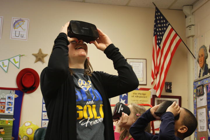 Group of student and the Principal exploring with Google expedition VR headset