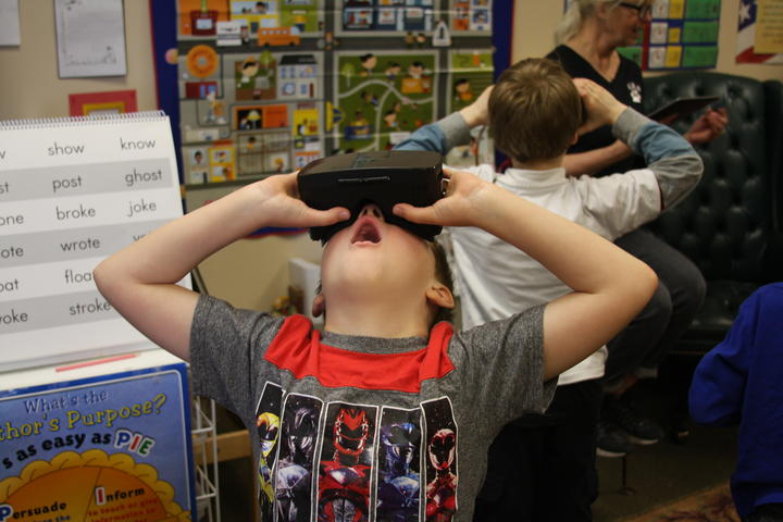 Boy amazed while using Google expedition VR headset 