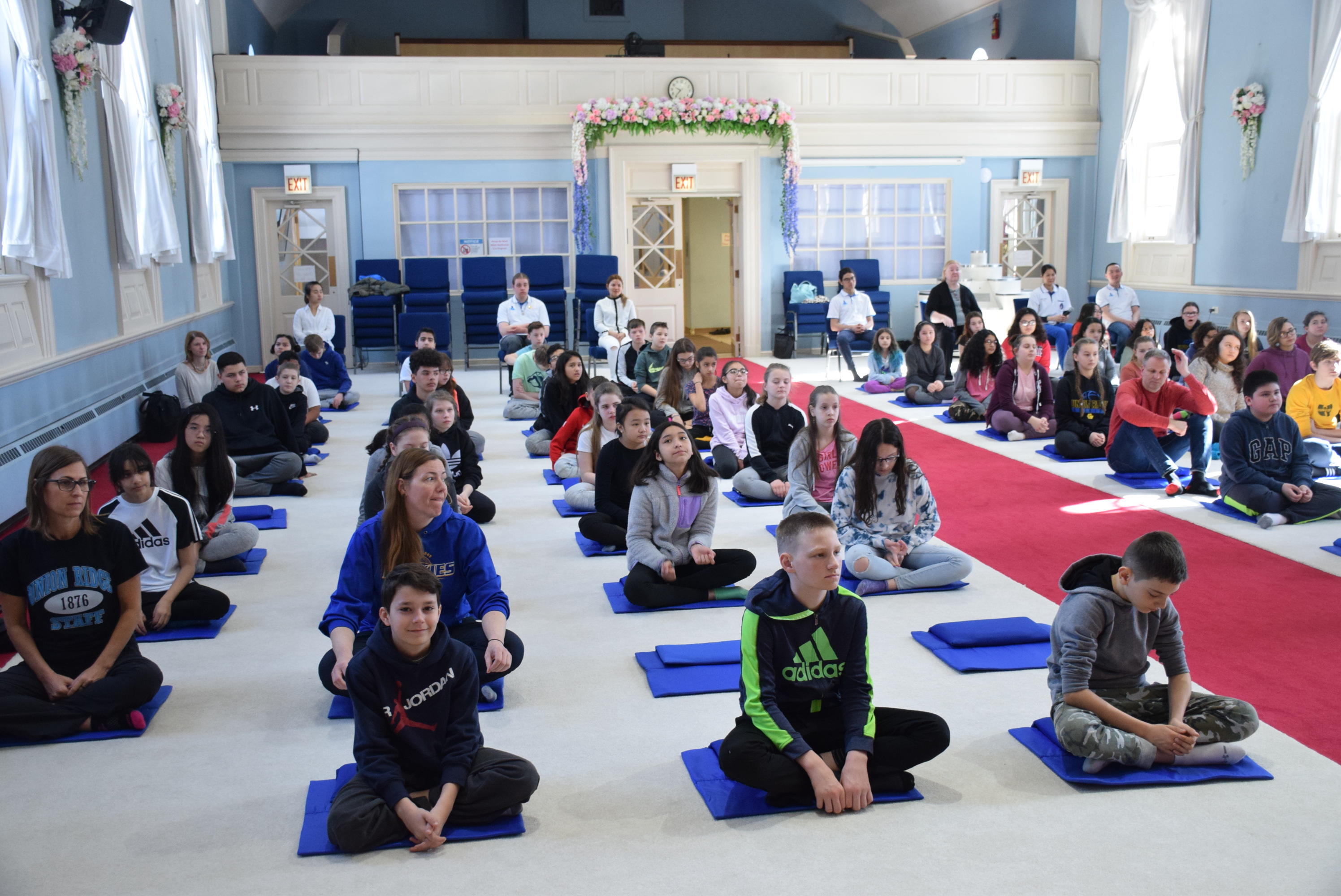 students and teachers in meditation 2