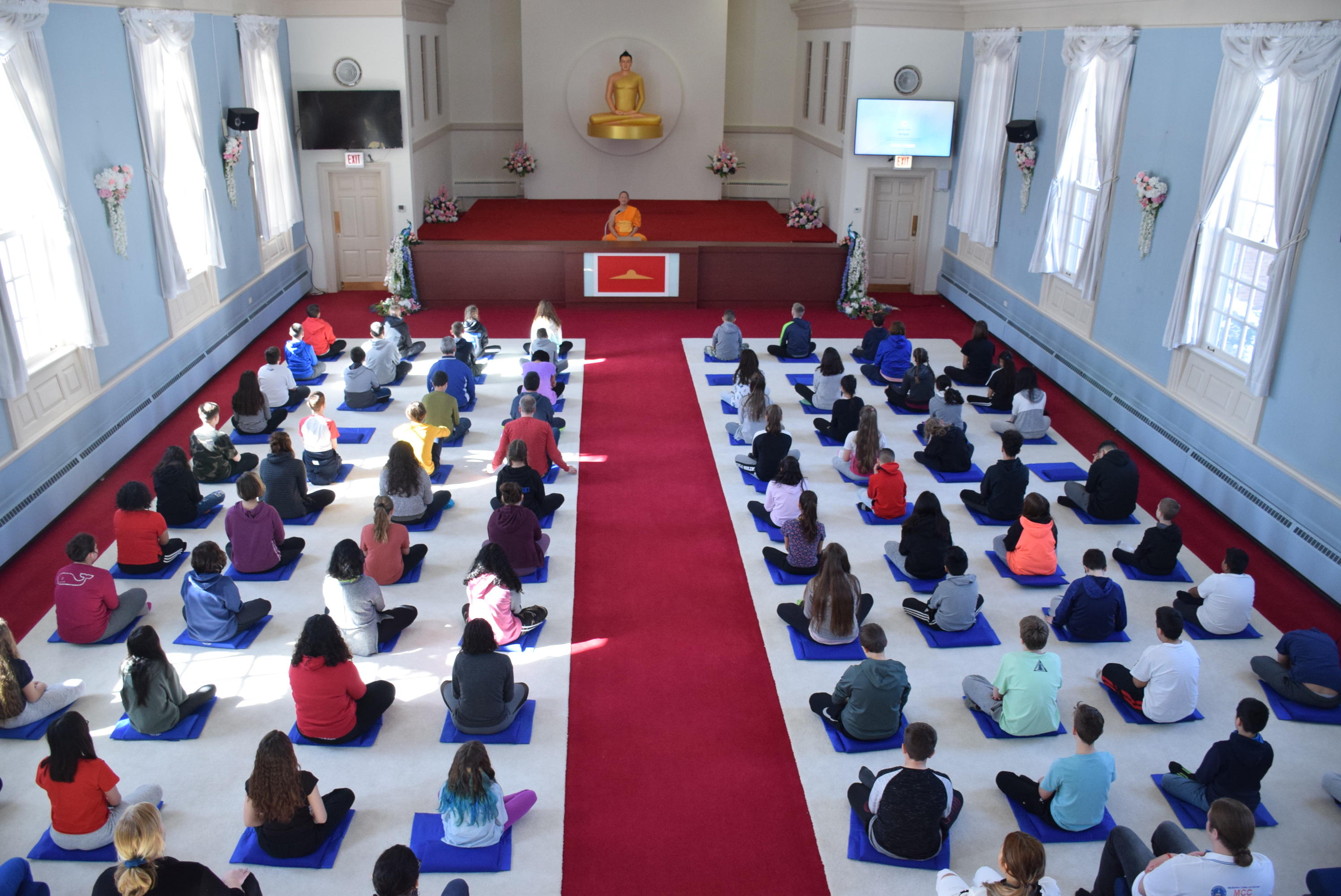 students and teachers in meditation 1