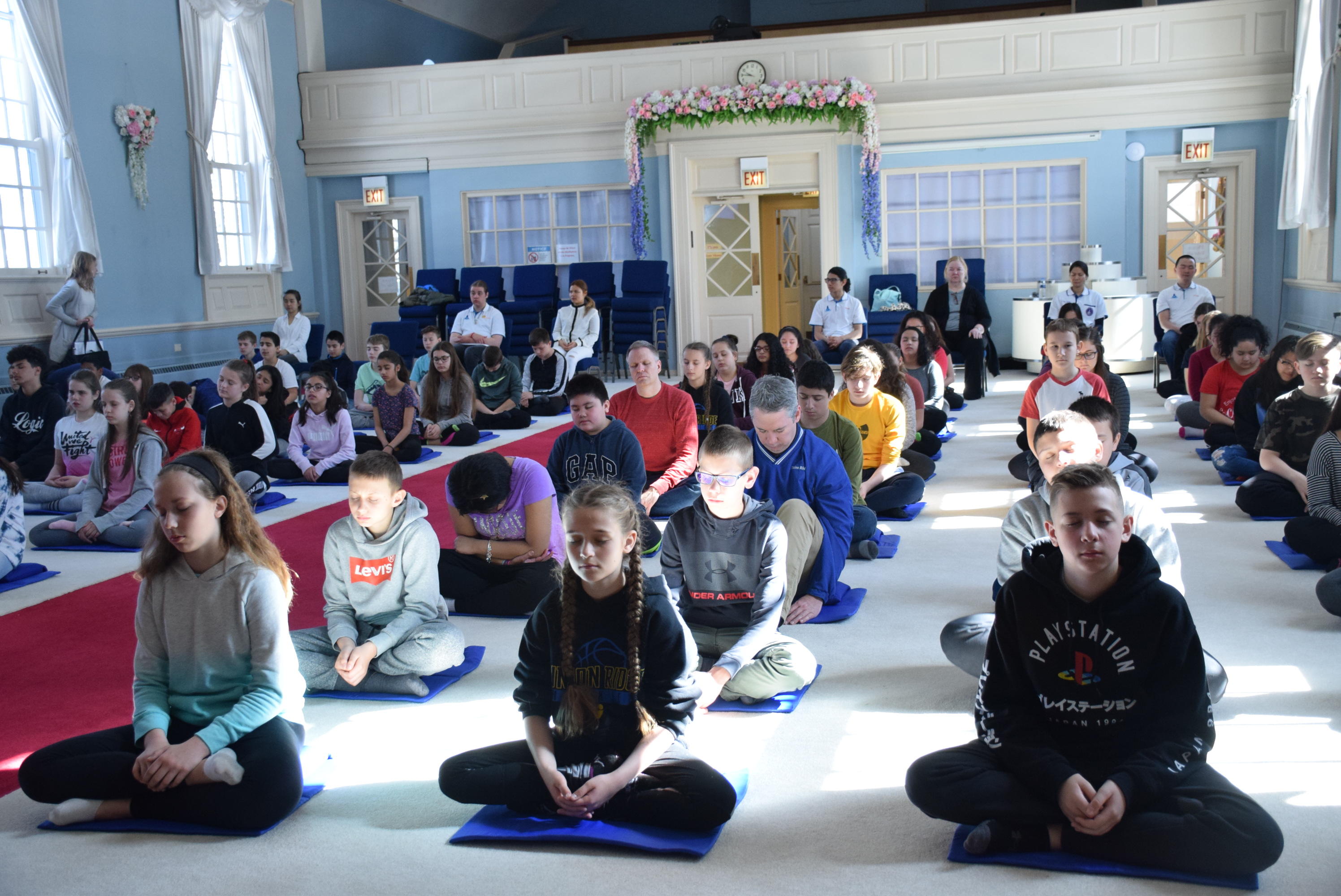 students and teachers in meditation