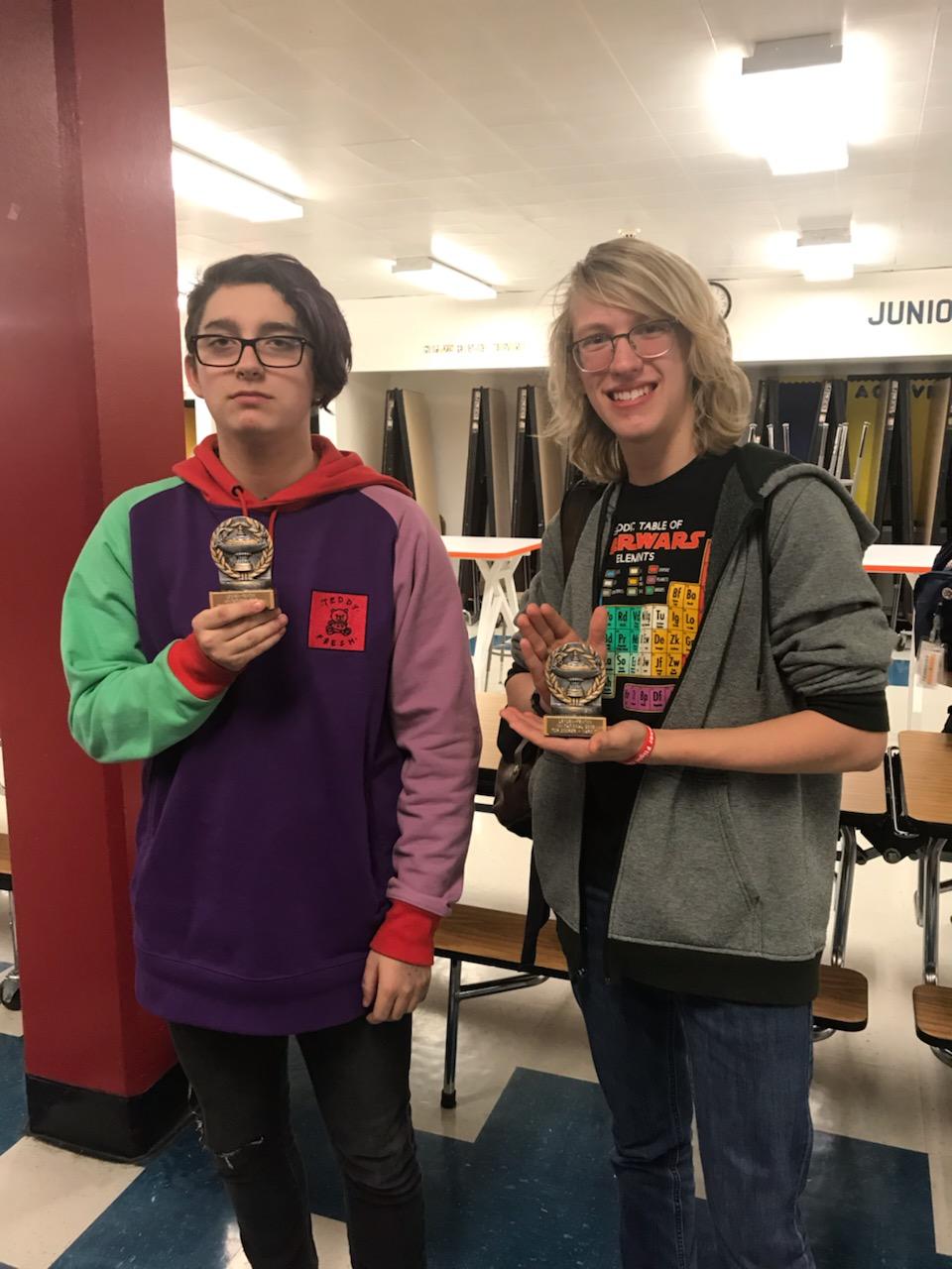 two students  showing their trophy
