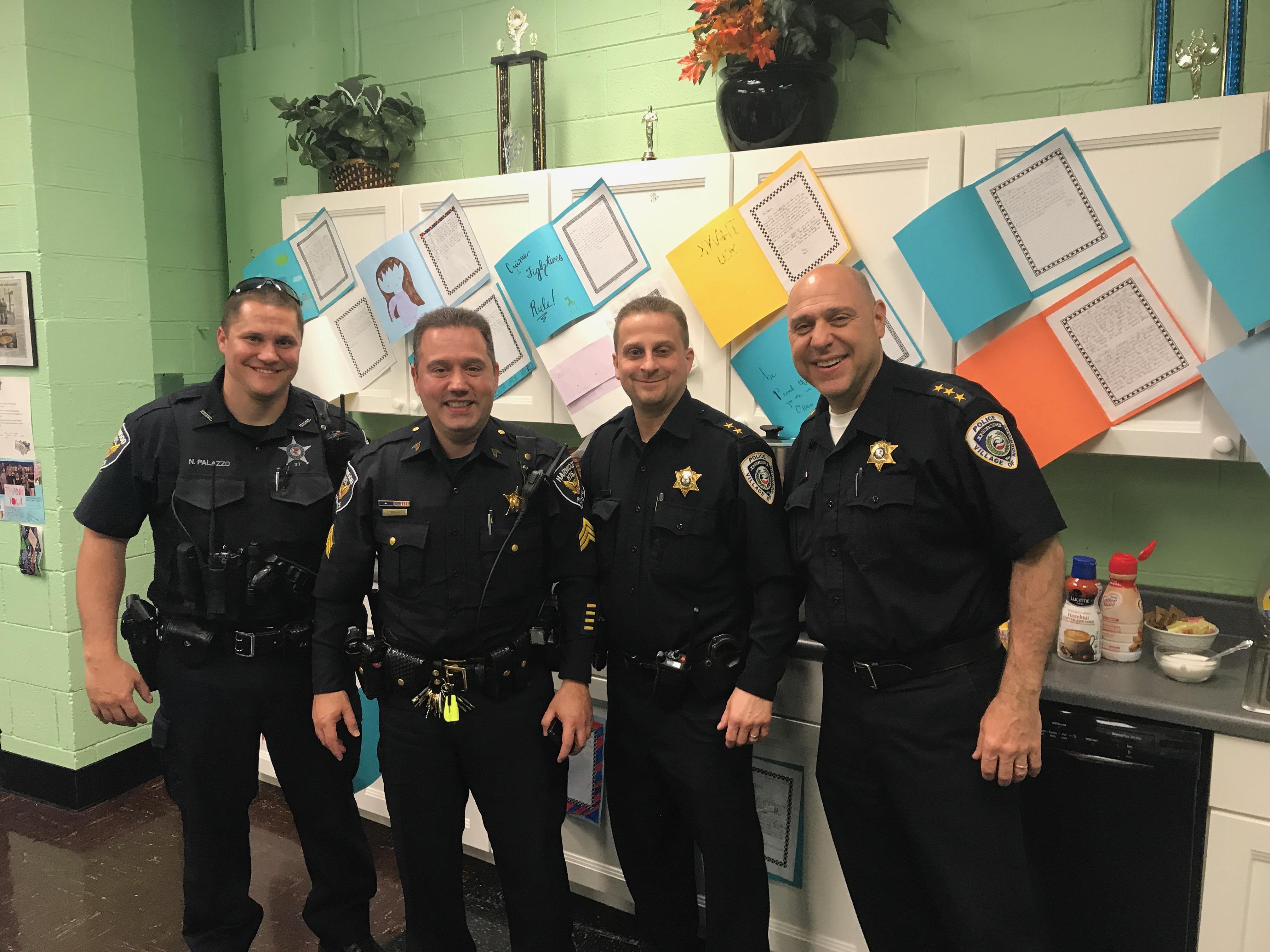 four Harwood Heights police officers posing for pictures