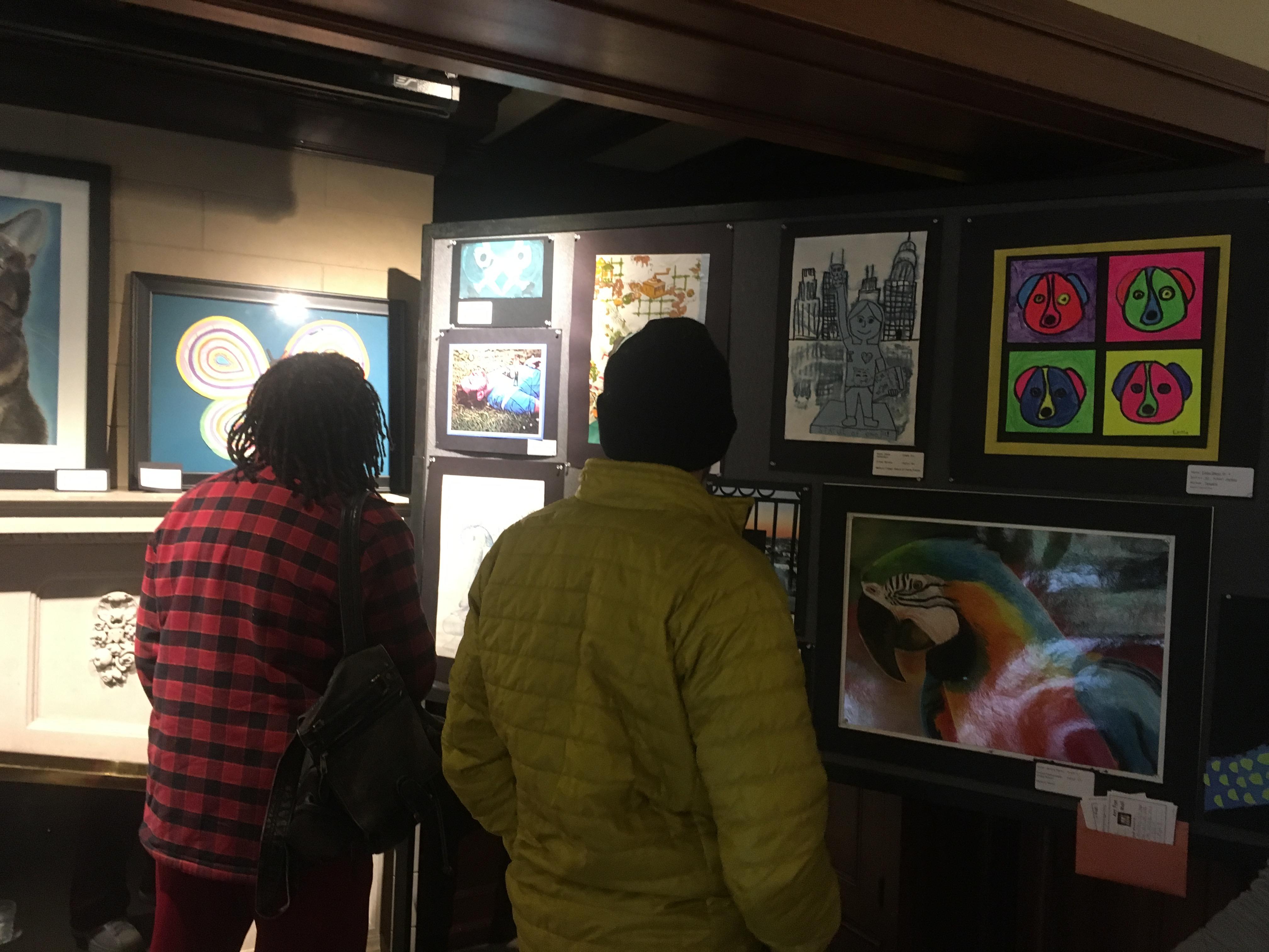 two people looking at artwork
