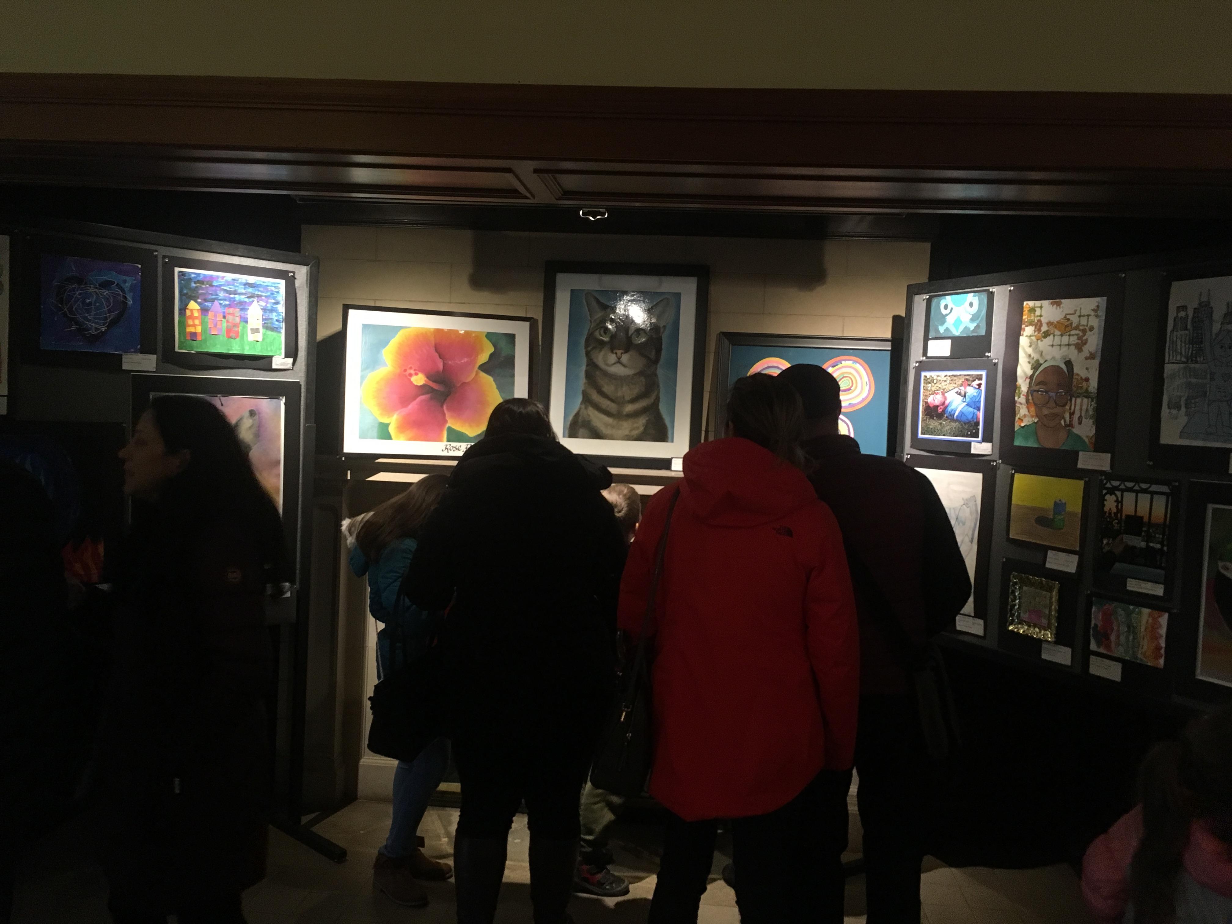 group of people looking at artwork
