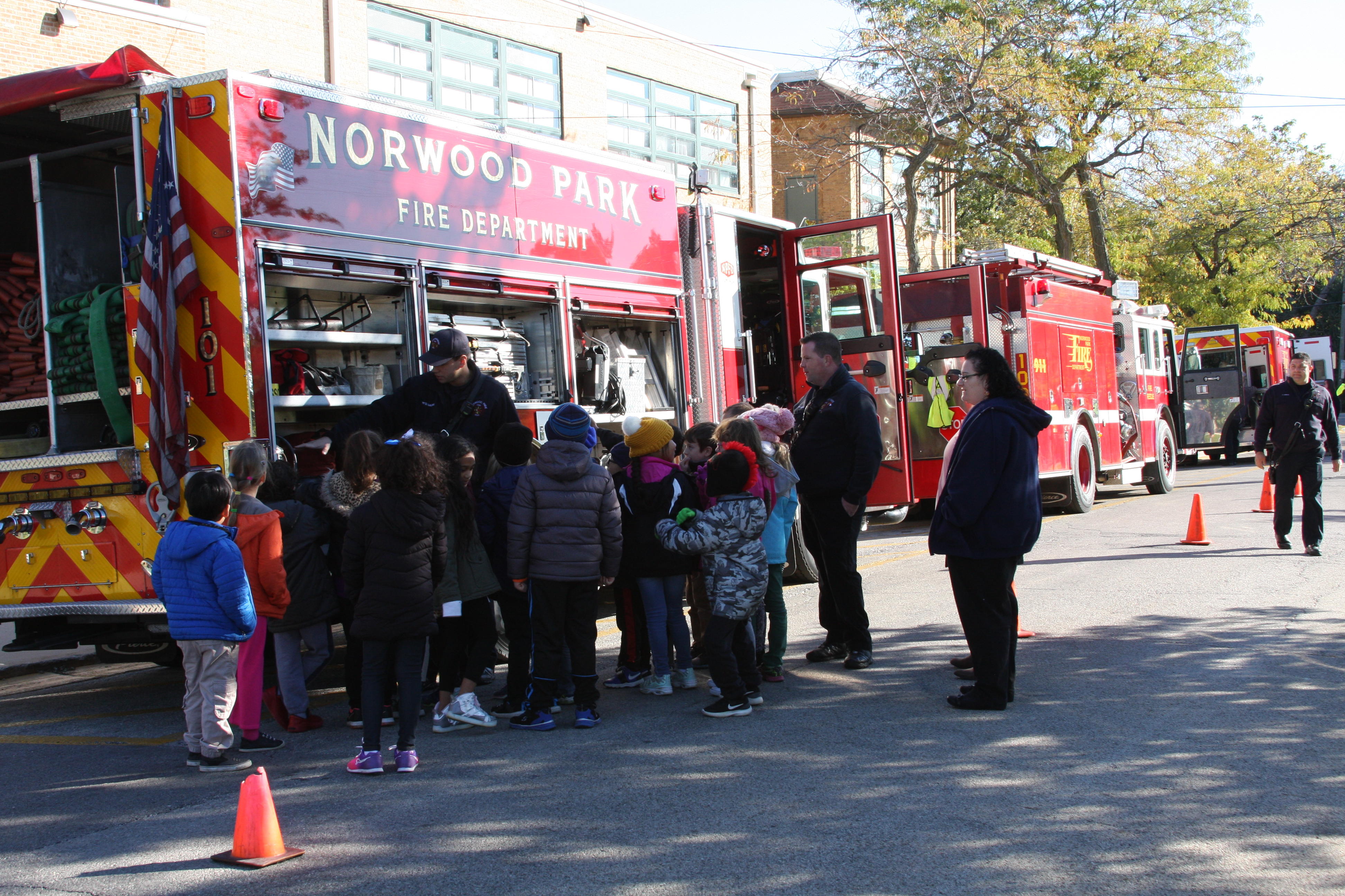 image of students and teacher standing by the fire truck 
