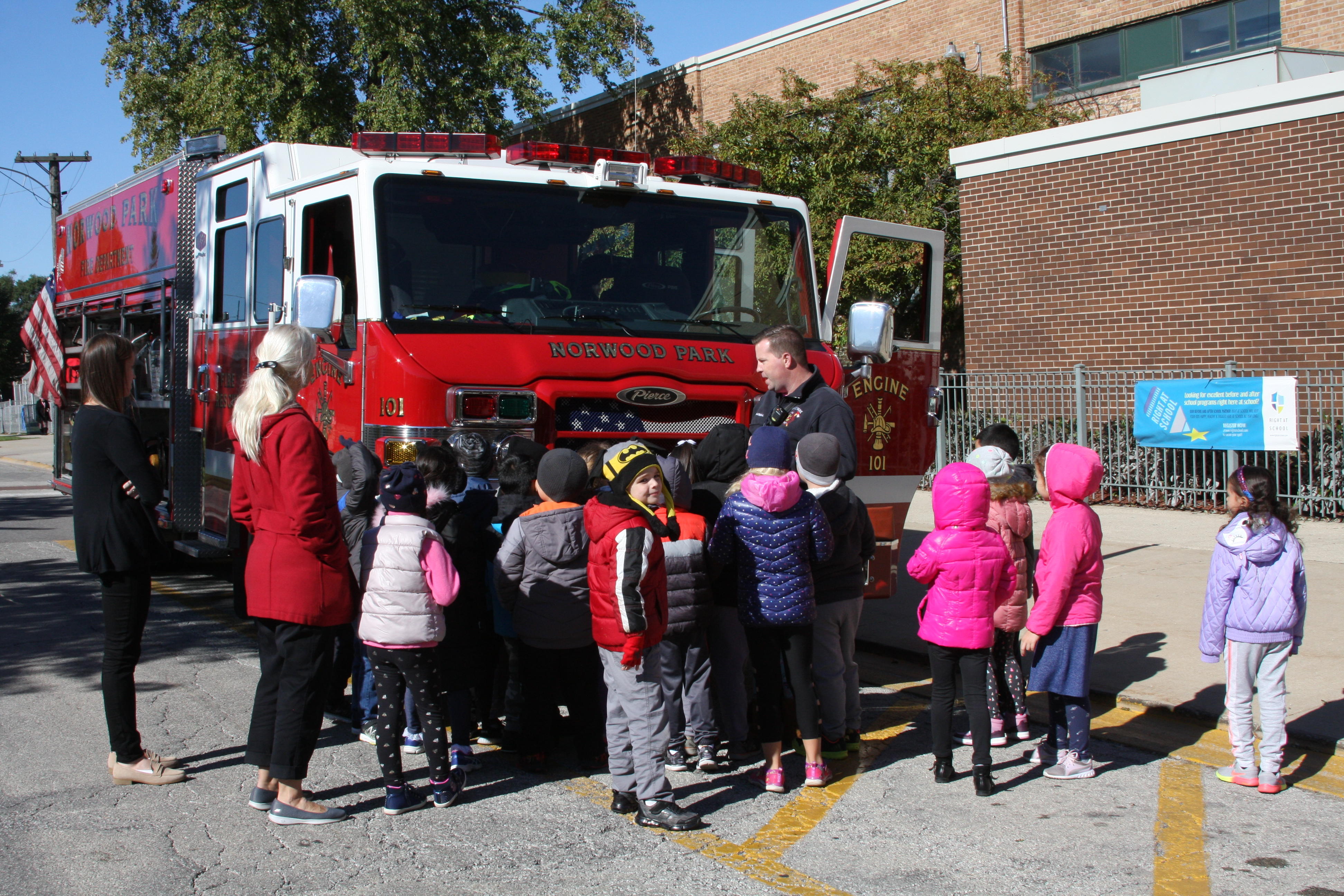 image of students standing by the fire truck
