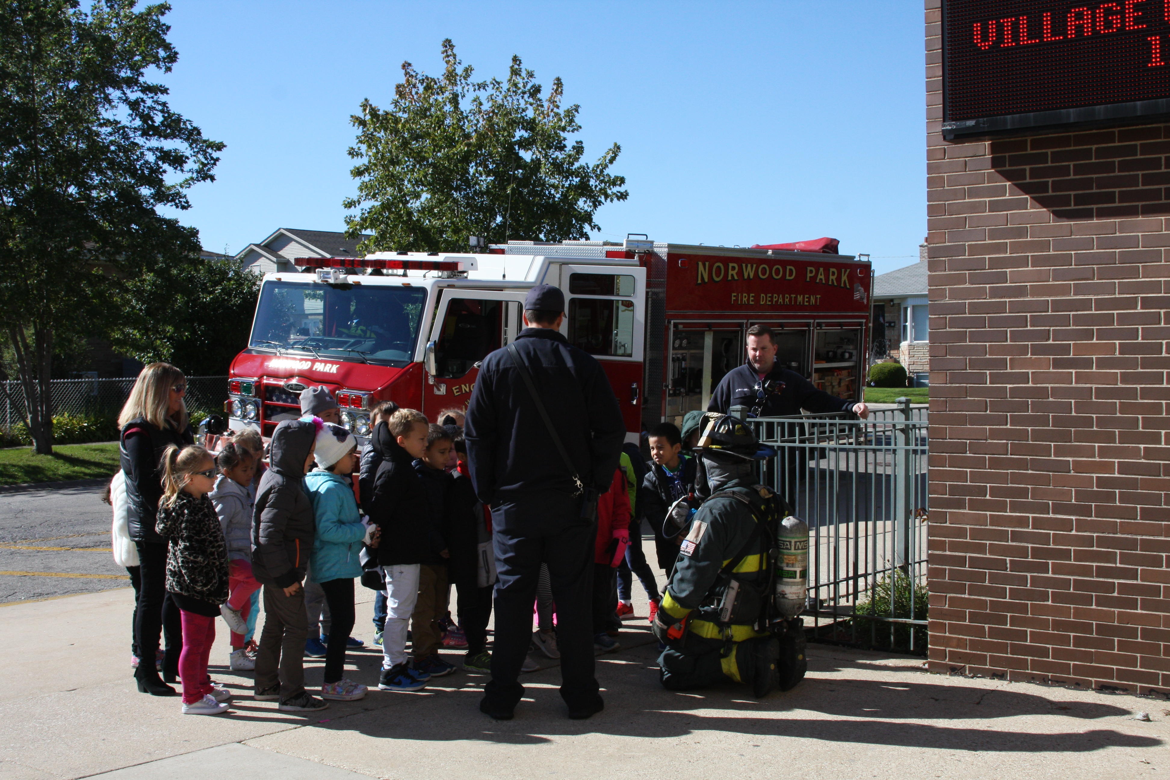 image of students listening to the firefighter 