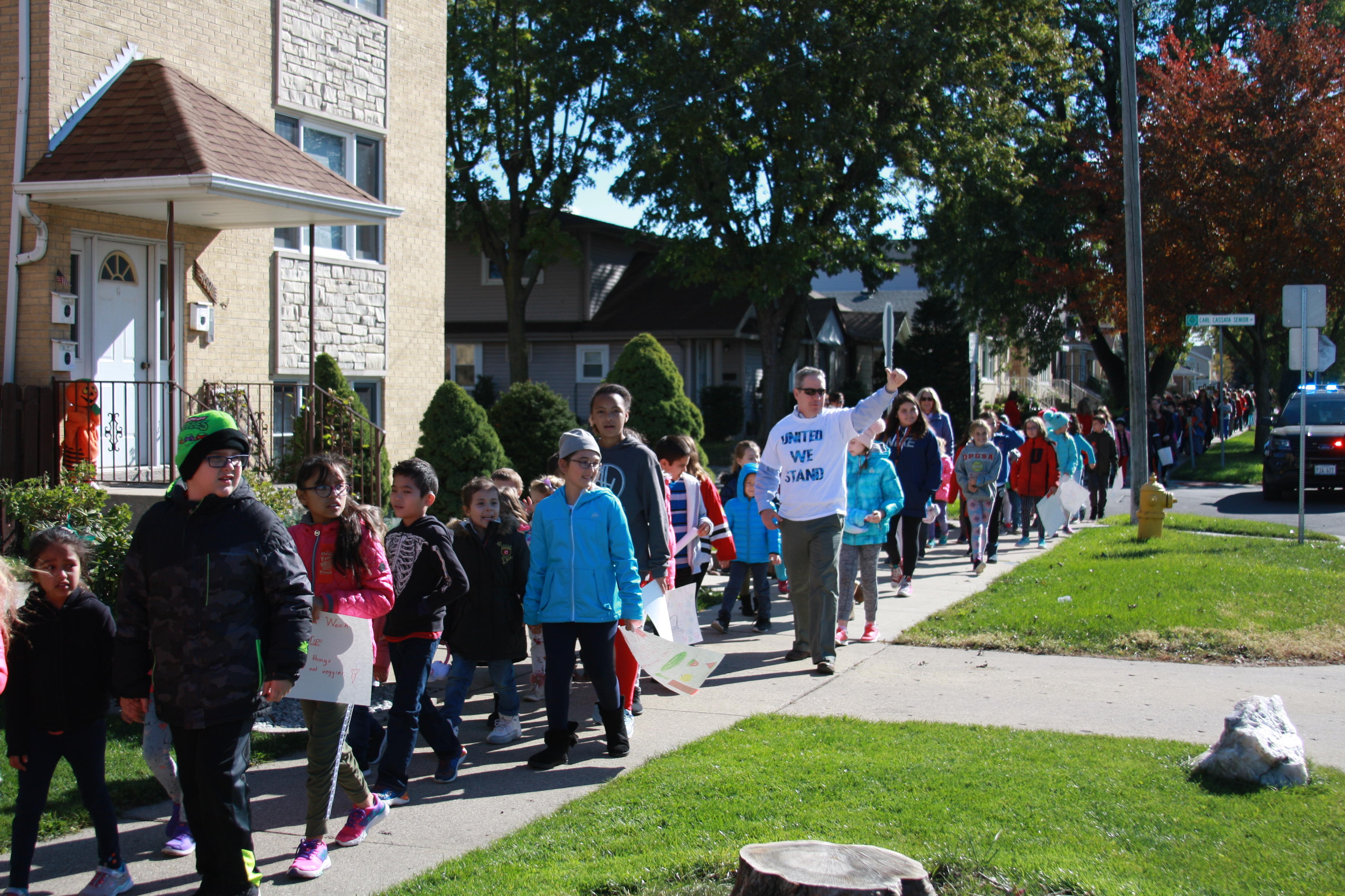 image of red ribbon walk, The superintendent waving to the community