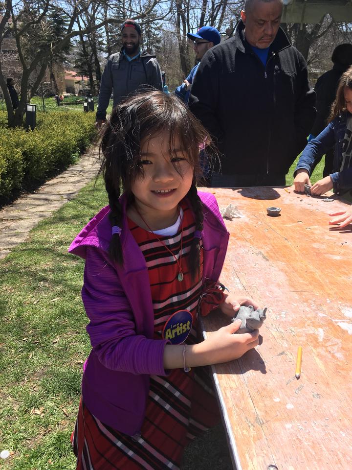 little girl holding artwork