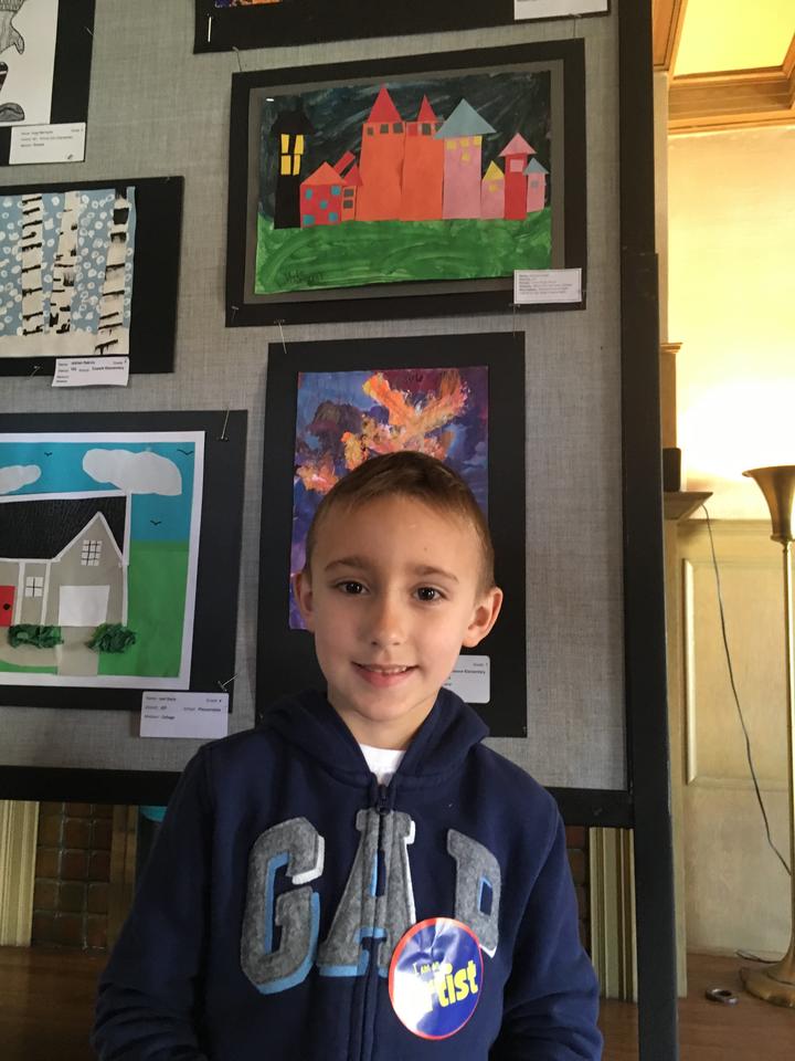 Union Ridge Student, boy Artist, posing with artwork
